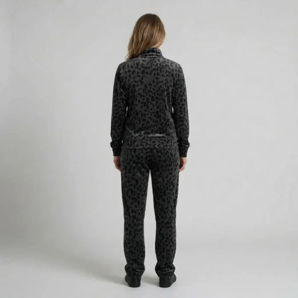 Back view of a woman wearing charcoal abstract leopard print velour tracksuit.