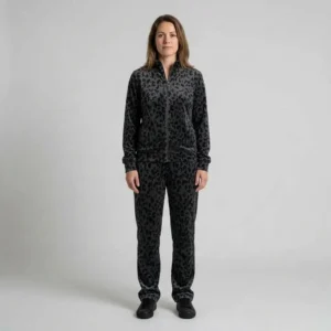 Front view of a woman wearing charcoal abstract leopard print velour tracksuit.