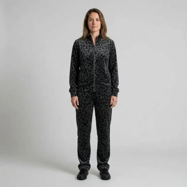 Front view of a woman wearing charcoal abstract leopard print velour tracksuit.
