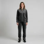 Front view of a woman wearing charcoal tonal spotted animal print velour tracksuit.