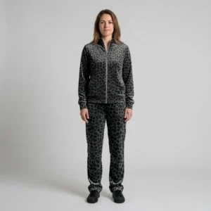 Front view of a woman wearing charcoal tonal spotted animal print velour tracksuit.
