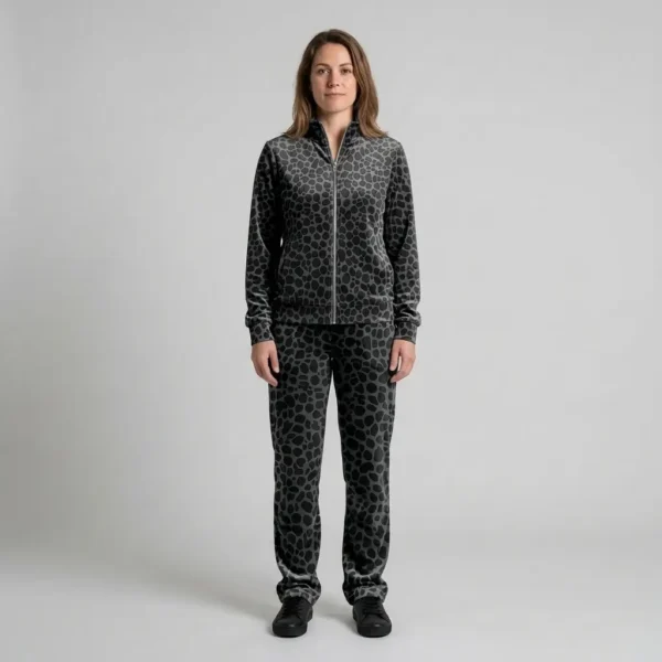 Front view of a woman wearing charcoal tonal spotted animal print velour tracksuit.