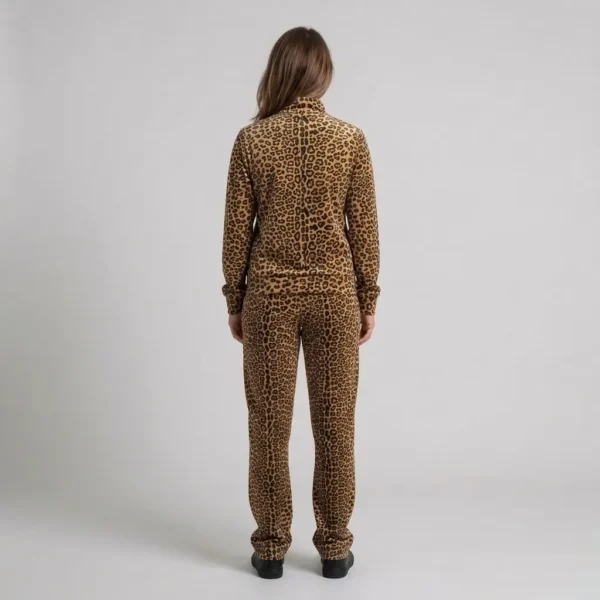 Back view of a woman wearing classic tan leopard print velour tracksuit.