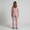Back view of a woman wearing dusty rose spotted animal print velour tracksuit.