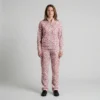 Front view of a woman wearing dusty rose spotted animal print velour tracksuit.