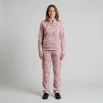 Front view of a woman wearing dusty rose spotted animal print velour tracksuit.