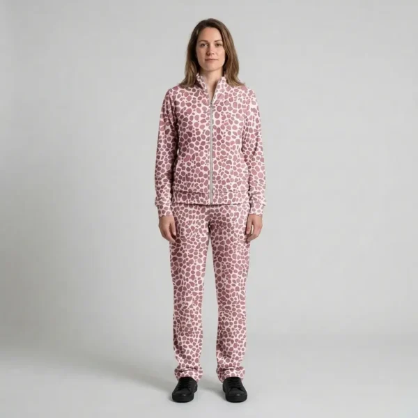 Front view of a woman wearing dusty rose spotted animal print velour tracksuit.