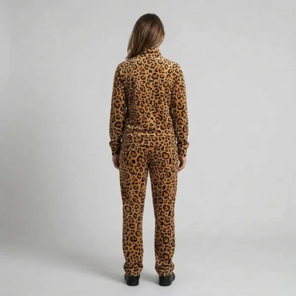 Back view of a woman wearing golden tan leopard print velour tracksuit.
