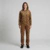 Front view of a woman wearing golden tan leopard print velour tracksuit.