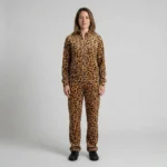 Front view of a woman wearing golden tan leopard print velour tracksuit.