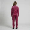 Back view of a woman wearing hot pink leopard print velour tracksuit.