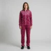 Front view of a woman wearing hot pink leopard print velour tracksuit.