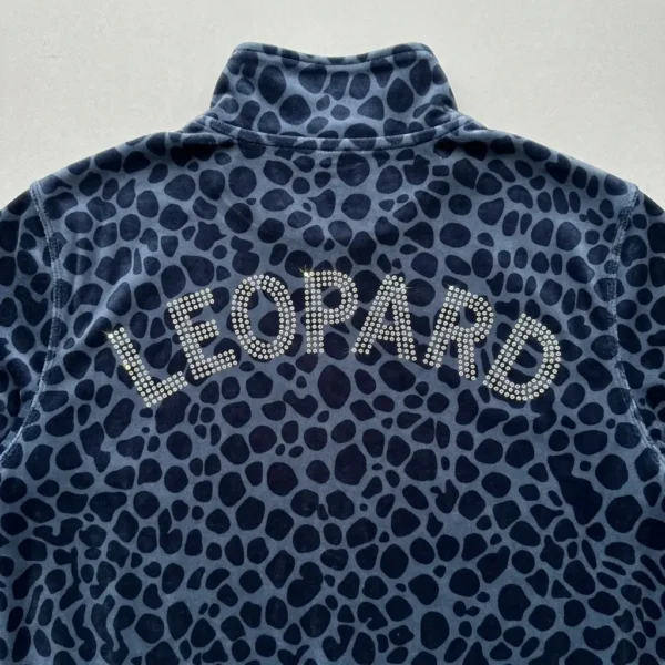 Closeup back view blue leopard printed velour track jacket with word "LEOPARD" written with rhinestones.
