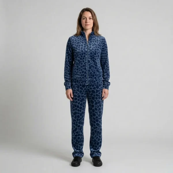 Front view of a woman wearing navy blue spotted animal print velour tracksuit.