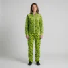 Front view of a woman wearing neon lime leopard print velour tracksuit.
