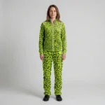 Front view of a woman wearing neon lime leopard print velour tracksuit.