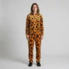 Front view of a woman wearing orange leopard print velour tracksuit.