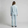 Back view of a woman wearing powder blue leopard print velour tracksuit.