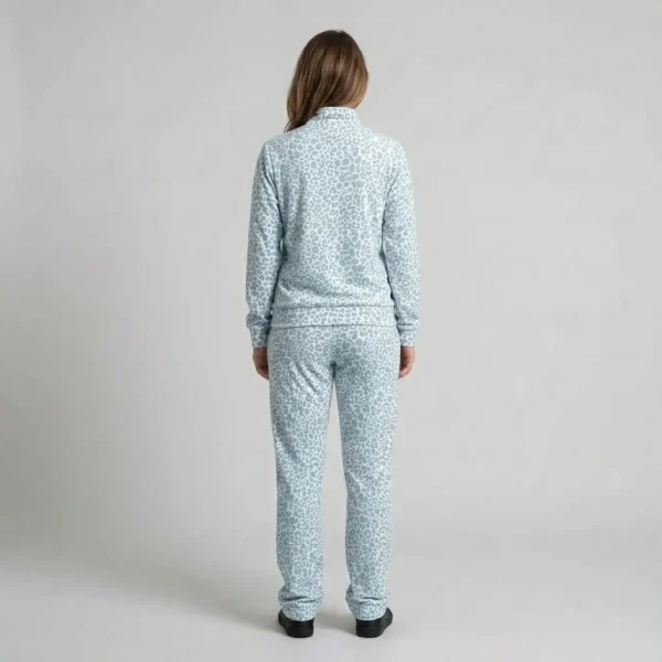 Back view of a woman wearing powder blue leopard print velour tracksuit.