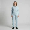 Front view of a woman wearing powder blue leopard print velour tracksuit.