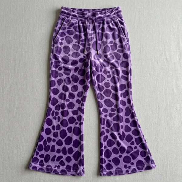 Purple spotted animal print velour flared track pants.
