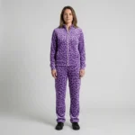 Front view of a woman wearing purple spotted animal print velour tracksuit.