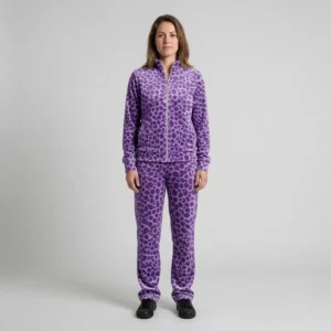 Front view of a woman wearing purple spotted animal print velour tracksuit.