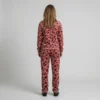 Back view of a woman wearing red blush pink leopard print velour tracksuit.