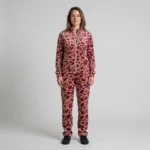 Front view of a woman wearing red blush pink leopard print velour tracksuit.
