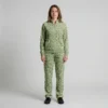 Front view of a woman wearing sage green spotted animal print velour tracksuit.
