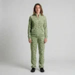 Front view of a woman wearing sage green spotted animal print velour tracksuit.