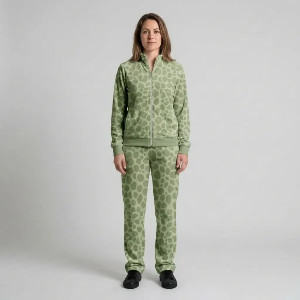 Front view of a woman wearing sage green spotted animal print velour tracksuit.