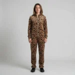 Front view of a woman wearing tan abstract leopard print velour tracksuit.