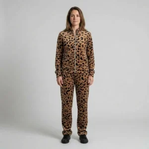 Front view of a woman wearing tan abstract leopard print velour tracksuit.