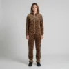 Front view of a woman wearing warm brown leopard print velour tracksuit.