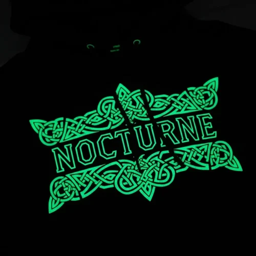 glow-in-the-dark-printed-hoodie-closeup Black hoodie with a bright green glow-in-the-dark print, featuring the word "NOCTURNE" within a complex Celtic knot design.