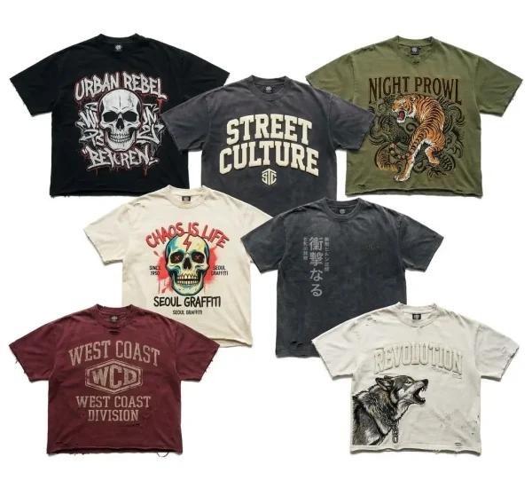 A collection of wholesale oversized graphic t-shirts showing various washes, puff prints, heavy distressing, and streetwear motifs like skulls, wolves, and tigers.